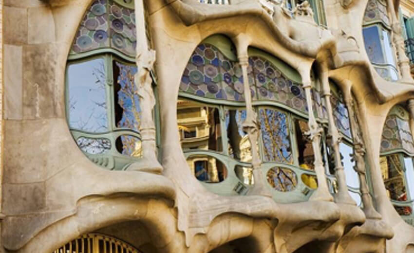 The undulating stone facade and balconies of Casa Batllo on Passeig de Gracia, Barcelona
