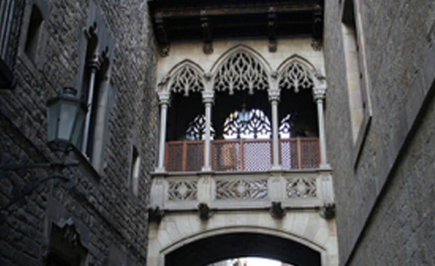 The Pont del Bisbe, a carved stone bridge crossing a narrow lane in Barcelona's Gothic Quarter