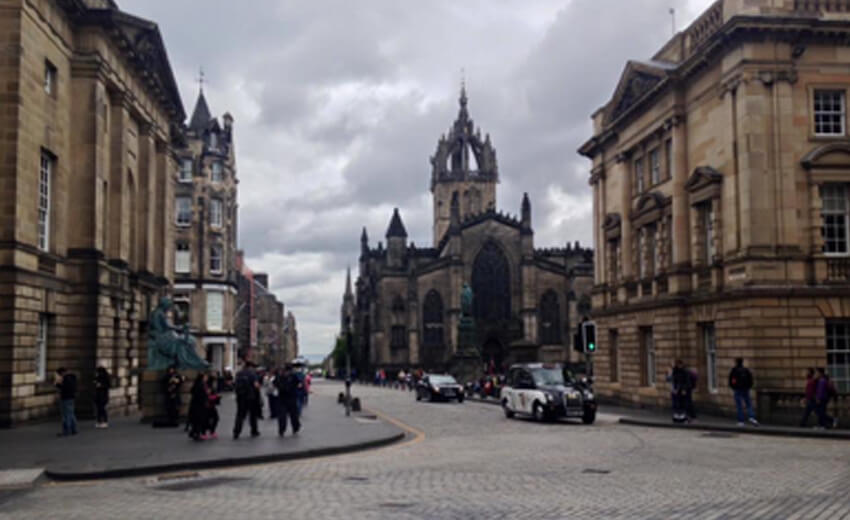 The Royal Mile in Edinburgh, gothic spires above a wide street under grey cloud
