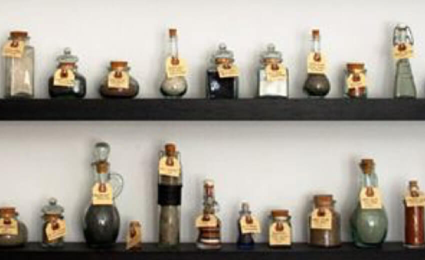 Two shelves of small souvenir figures and bottles collected from different countries
