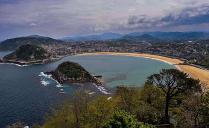La Concha bay in San Sebastian seen from above, the island in the middle and the beach curving round